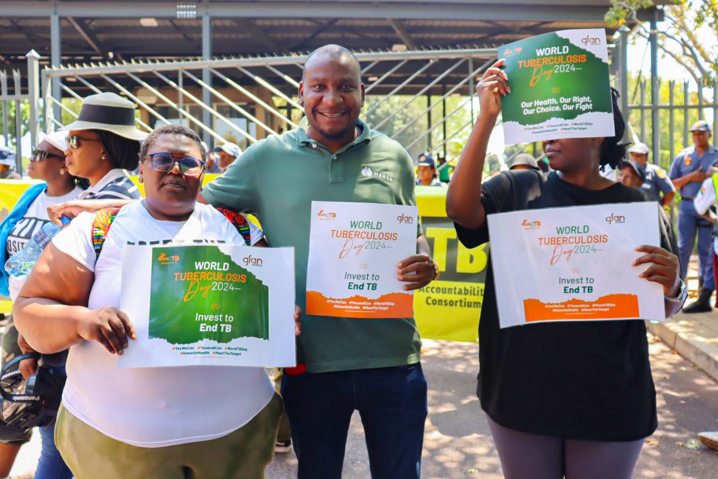 Advocates holding World TB Day 2024 placards reading Invest to End TB